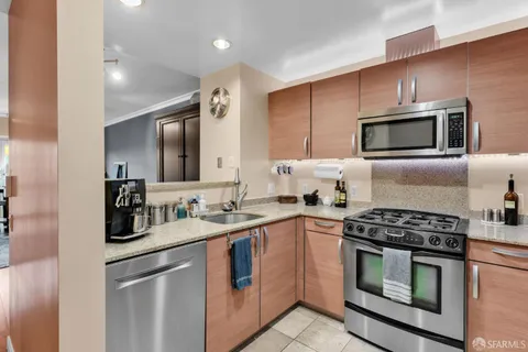 a kitchen with stainless steel appliances a stove sink and microwave
