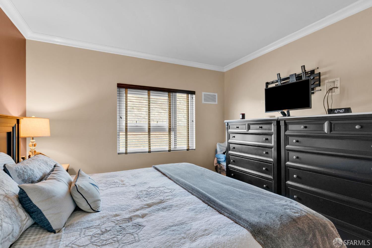 1 Mandalay Place, Unit 908 South San Francisco, CA 94080 - Photo 22 of 40 a bedroom with a bed and television