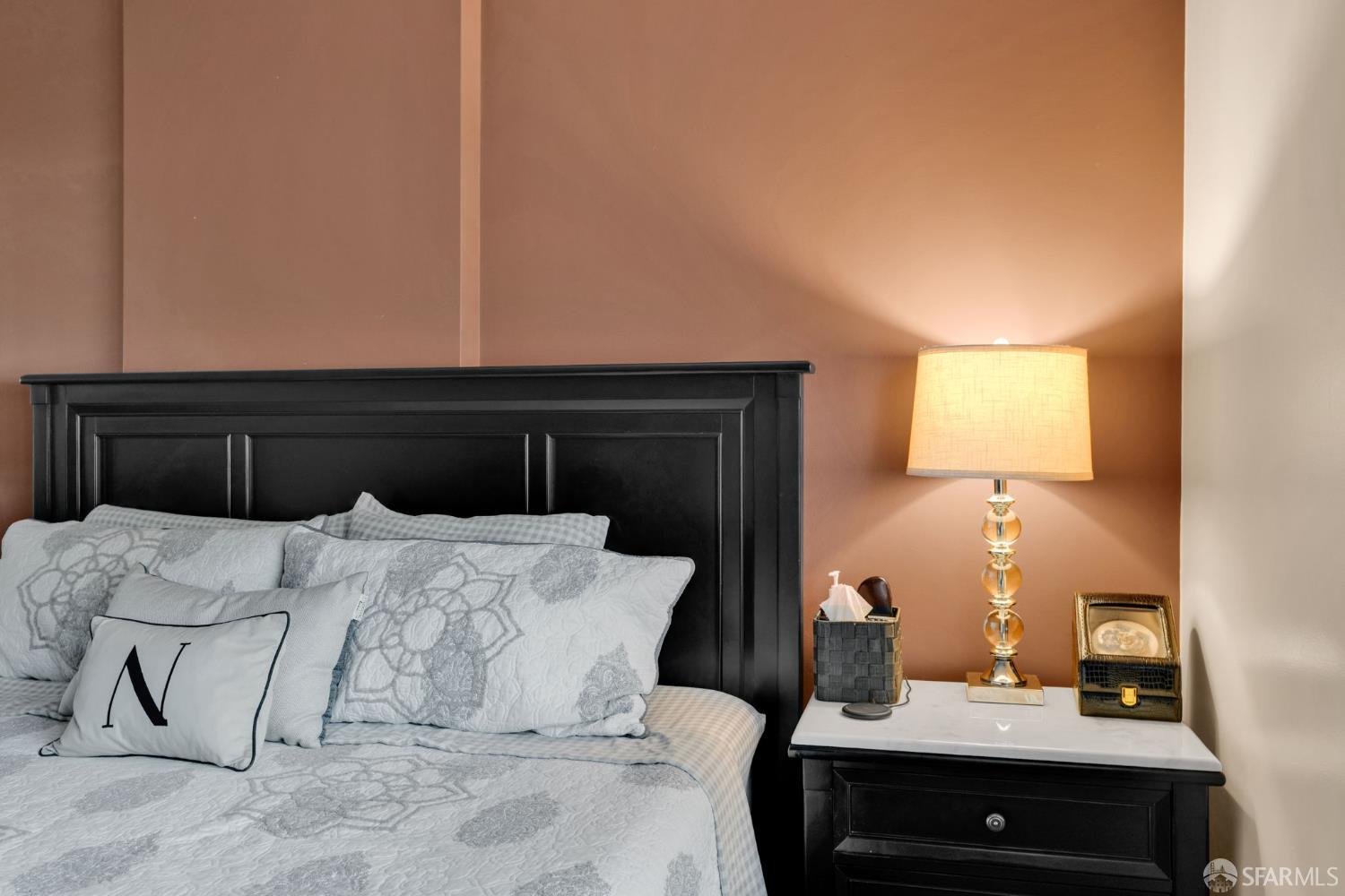 1 Mandalay Place, Unit 908 South San Francisco, CA 94080 - Photo 24 of 40 a bedroom with a bed and a lamp on dresser