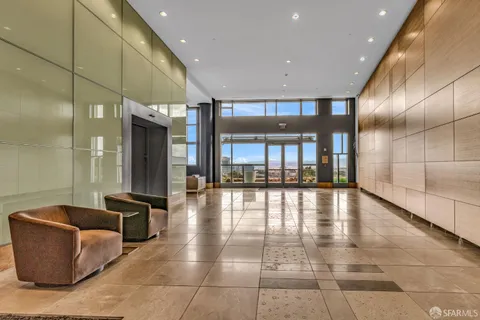 a lobby with furniture and a rug