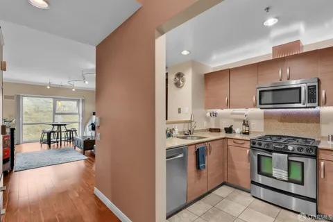 a kitchen with stainless steel appliances a stove a sink and a microwave