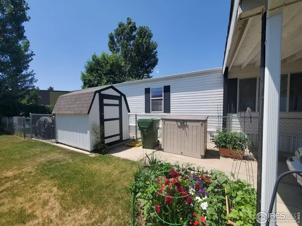 a view of a house with a yard and potted plants
