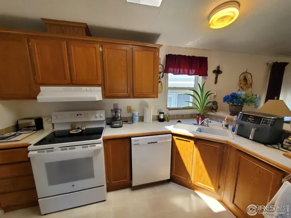 a kitchen with granite countertop a sink and a stove top oven