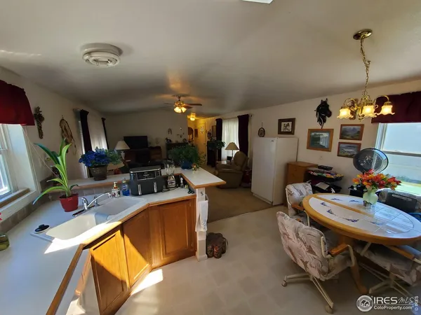 a room with furniture a flat screen tv and a sink