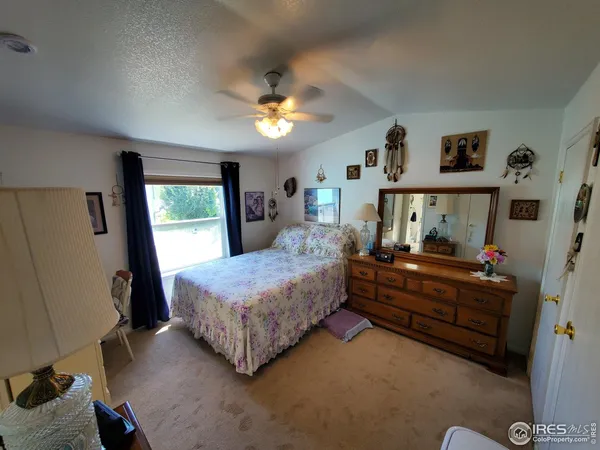 a bedroom with bed and a window