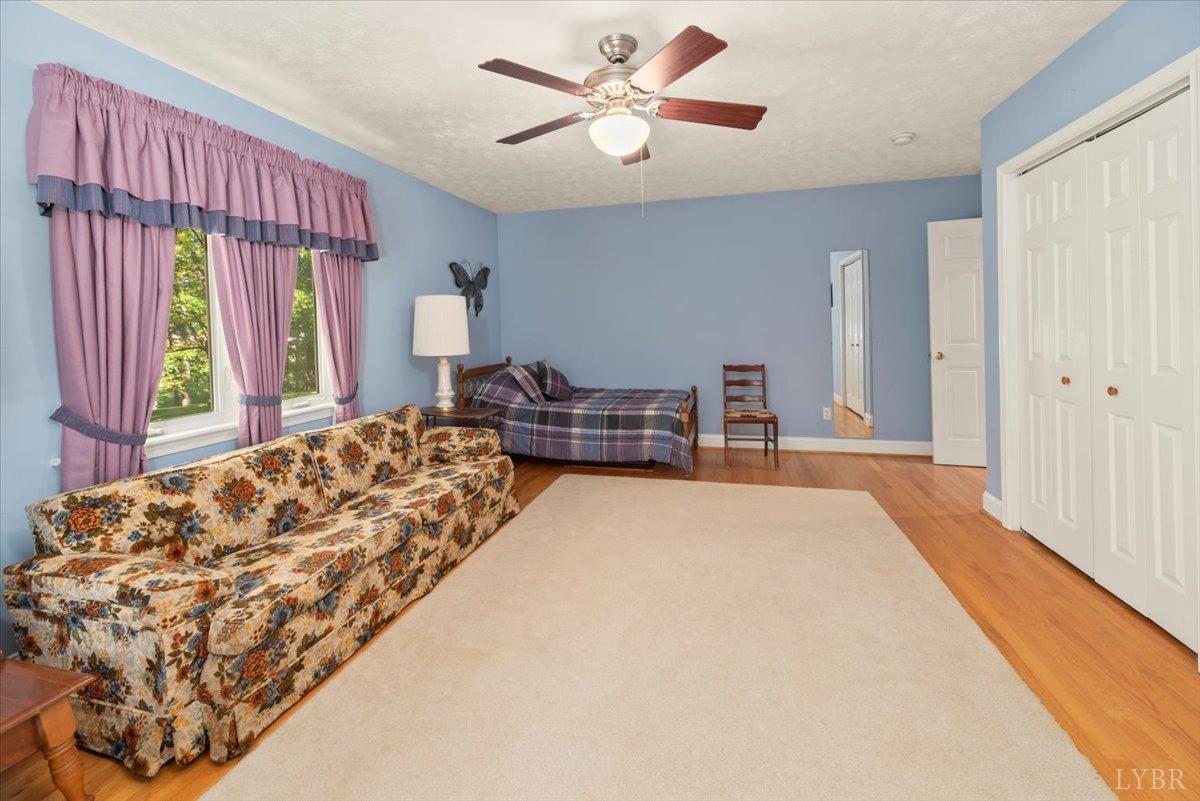 159 Blue Ridge Lane Amherst, VA 24521 - Photo 26 of 71 a bedroom with a bed and a chandelier