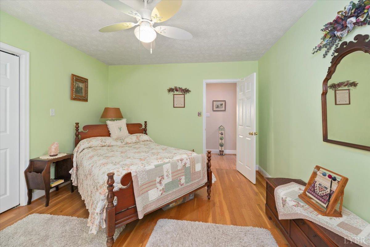 159 Blue Ridge Lane Amherst, VA 24521 - Photo 28 of 71 a bedroom with a bed and wooden floor