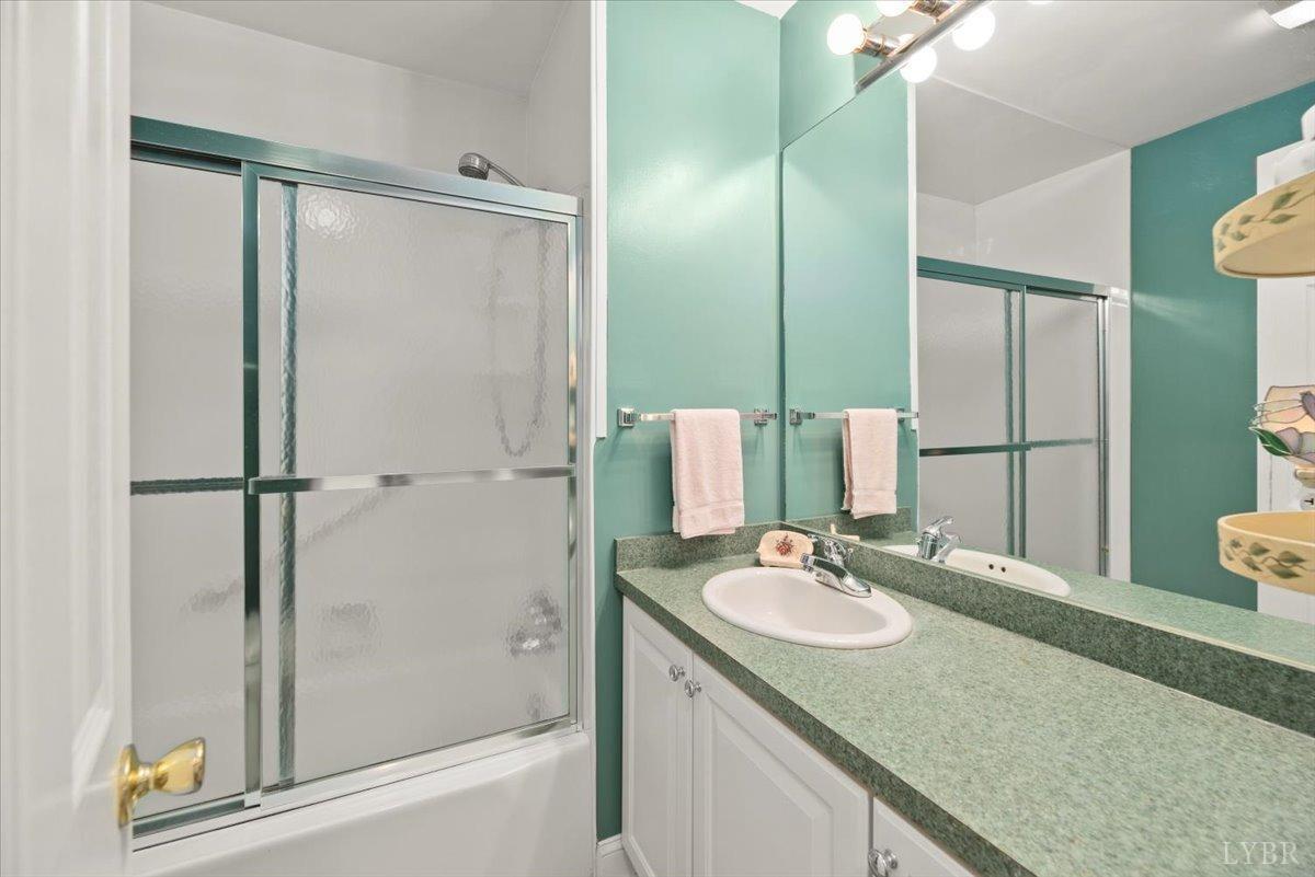 159 Blue Ridge Lane Amherst, VA 24521 - Photo 29 of 71 a bathroom with a granite countertop sink mirror and shower