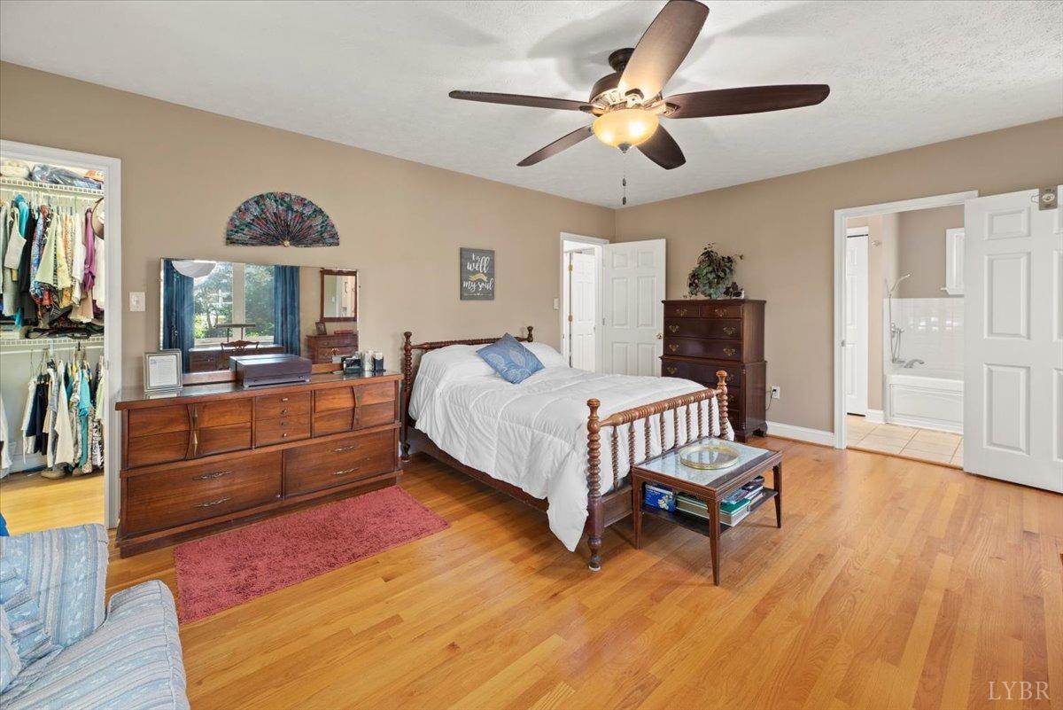 159 Blue Ridge Lane Amherst, VA 24521 - Photo 32 of 71 a bedroom with a bed and a chandelier