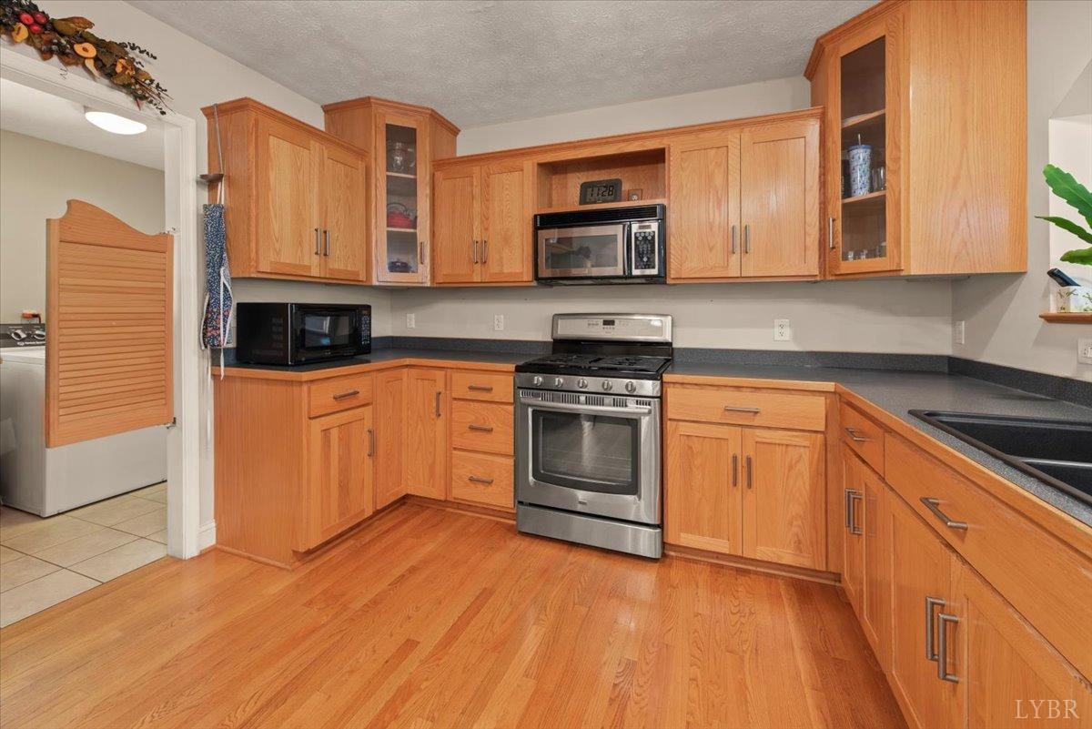159 Blue Ridge Lane Amherst, VA 24521 - Photo 9 of 71 a kitchen with stainless steel appliances granite countertop a stove a sink and a microwave