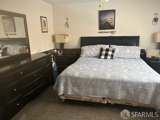 19481 Rambling Oak Drive Redding, CA 96003 - Photo 32 of 62 a bedroom with a bed and wooden floor