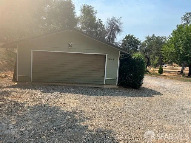 a view of house with backyard and sitting area