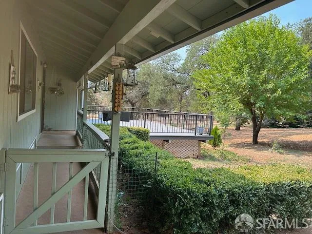 a view of backyard with barbeque grill and outdoor seating