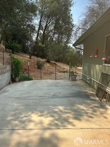 a backyard of a house with yard and outdoor seating