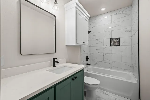 a bathroom with a sink a toilet and shower