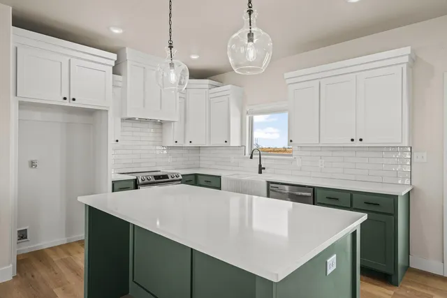 a kitchen with kitchen island a stove a sink a center island and cabinets
