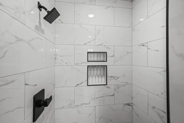 a spacious bathroom with a tub sink and mirror