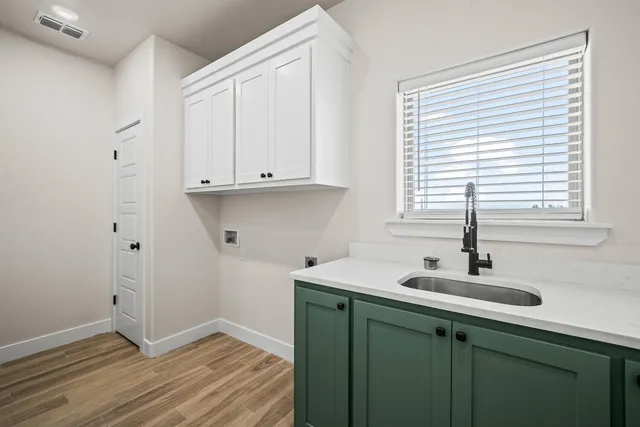 a kitchen with a sink and wooden cabinets