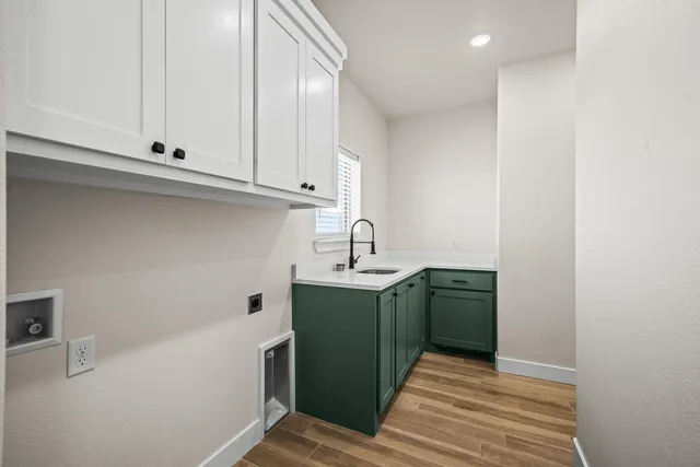 a room with a sink cabinets and utility