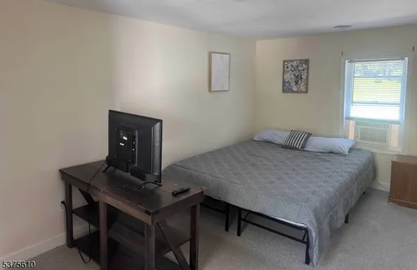 a bedroom with a bed and a desk