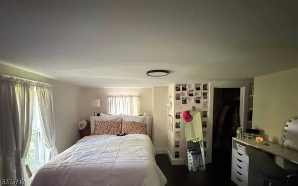 a bedroom with bed and a window