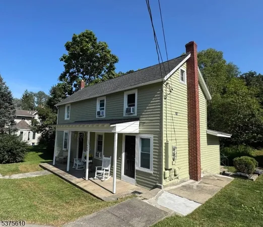 a view of a house with backyard and porch