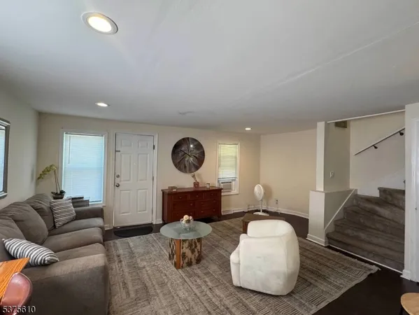 a living room with furniture and a mirror