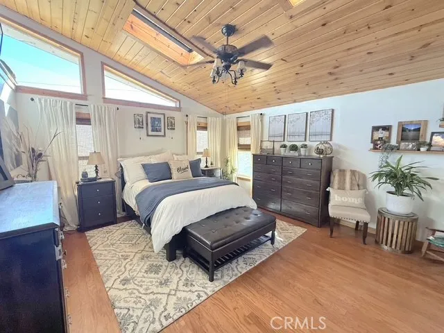 a bedroom with a bed and ceiling fan