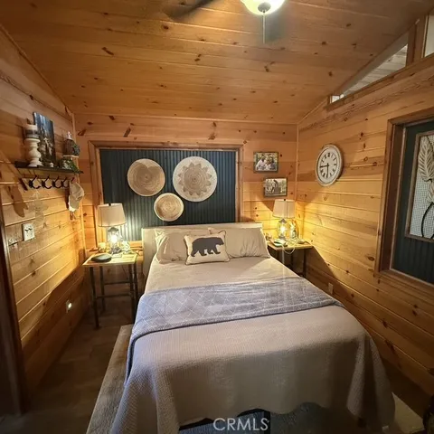 a living room with a bed furniture and a large window