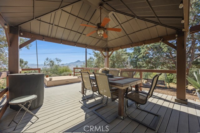 9780 Fay Ranch Road Weldon, CA 93283 - Photo 40 of 47 a view of a roof deck with table and chairs under an umbrella