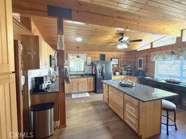 a kitchen with stainless steel appliances granite countertop a sink and a refrigerator