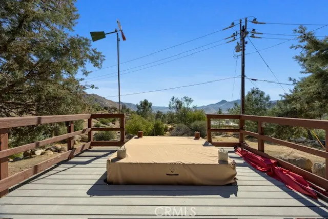 a roof deck with wooden floor and fence