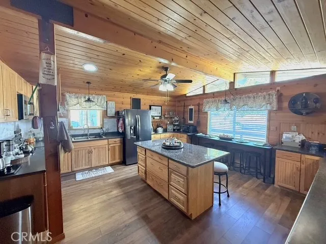 a kitchen with stainless steel appliances granite countertop a stove and a wooden floors