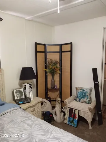 a bedroom with a bed and large window