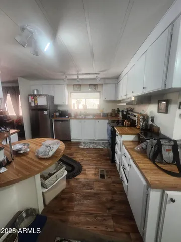 a kitchen with sink stove and cabinets