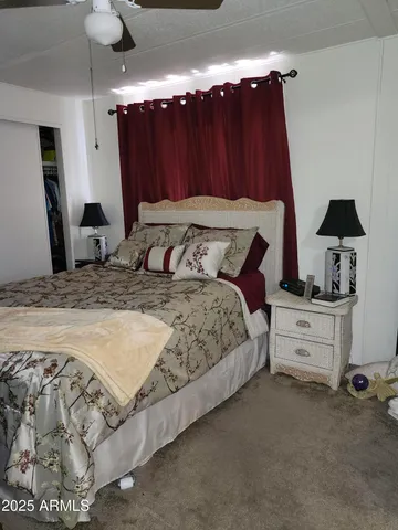 a bedroom with a bed and a chandelier