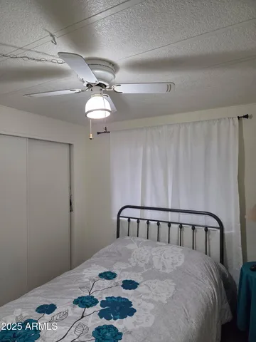 a large bed sitting in a bedroom next to a window