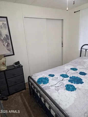 a bedroom with a bed and a dresser