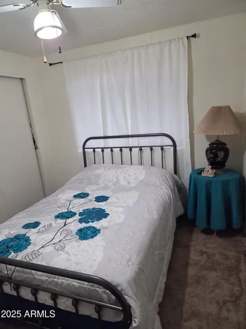 a bedroom with a bed and ceiling fan