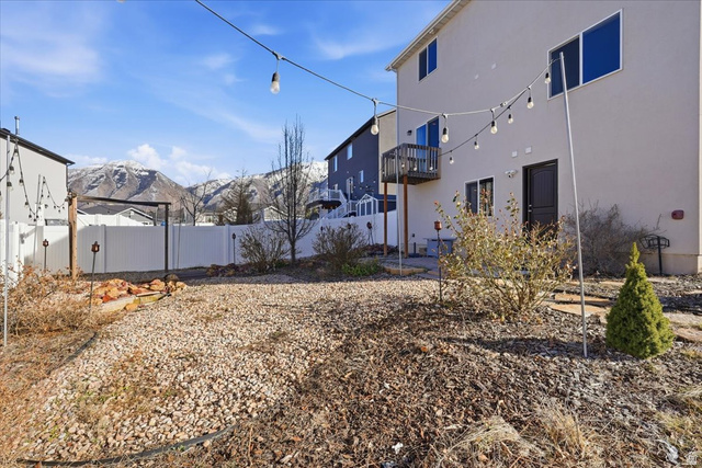 1218 Moonlight Drive Elk Ridge, UT 84651 - Photo 38 of 44 Fenced backyard featuring a mountain view, a patio, and a balcony