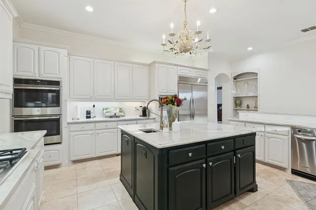 a kitchen with a sink a counter top space and appliances