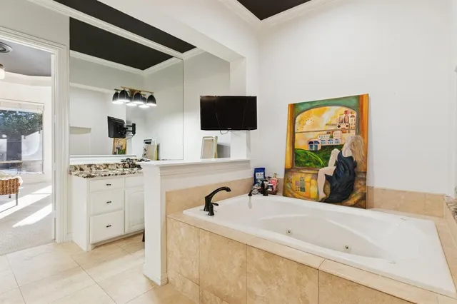 a bedroom with a bed mirror and window