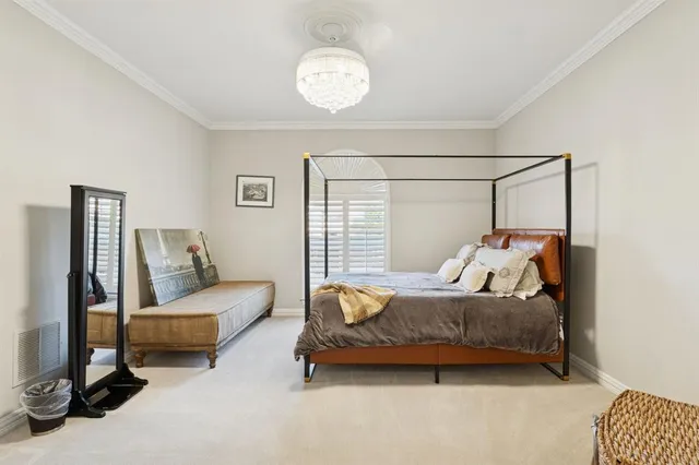 a bedroom with bed and a chandelier