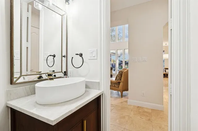a bathroom with a sink vanity and a mirror