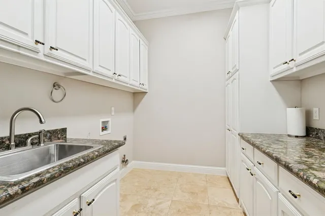 a kitchen with granite countertop a sink and cabinets