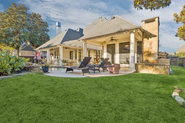 a view of a house with a backyard porch and sitting area