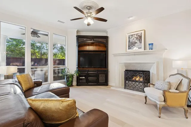 a living room with furniture a flat screen tv and a fireplace