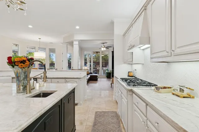 a kitchen with stainless steel appliances granite countertop a sink stove and cabinets