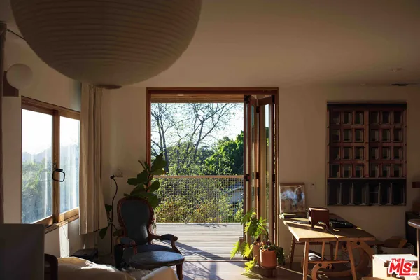 a living room with furniture and large windows
