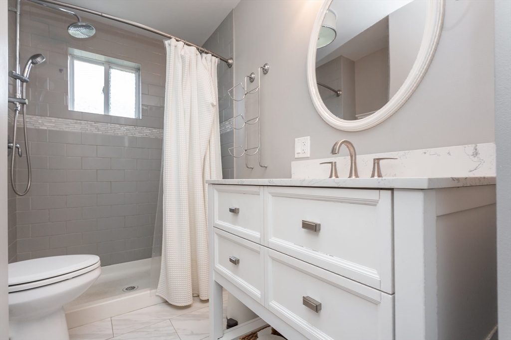 724 High Street Fall River, MA 02720 - Photo 25 of 39 a bathroom with a sink a toilet and a mirror